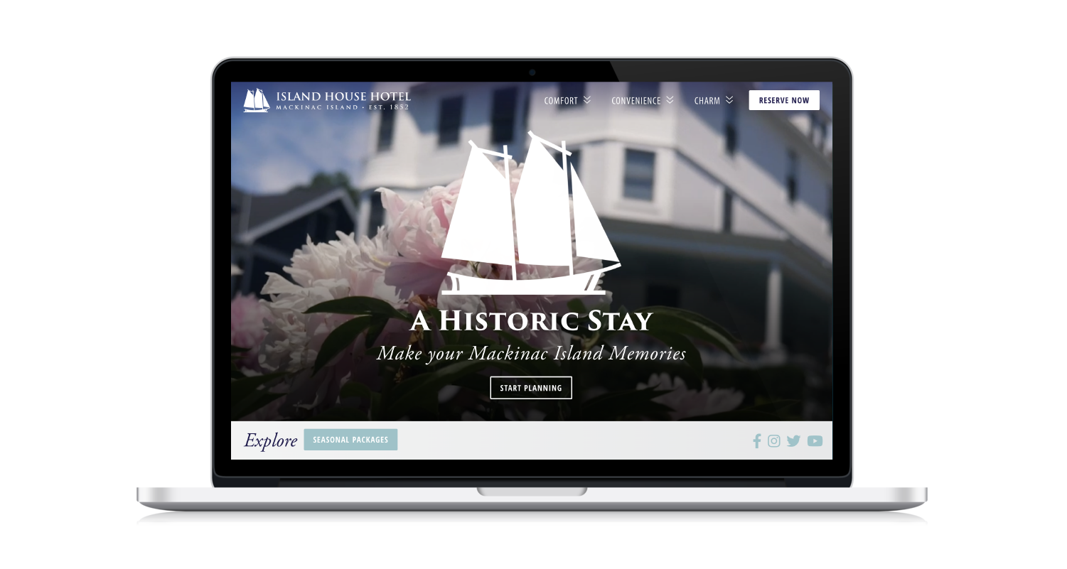 Macbook with Island House Hotel website on screen